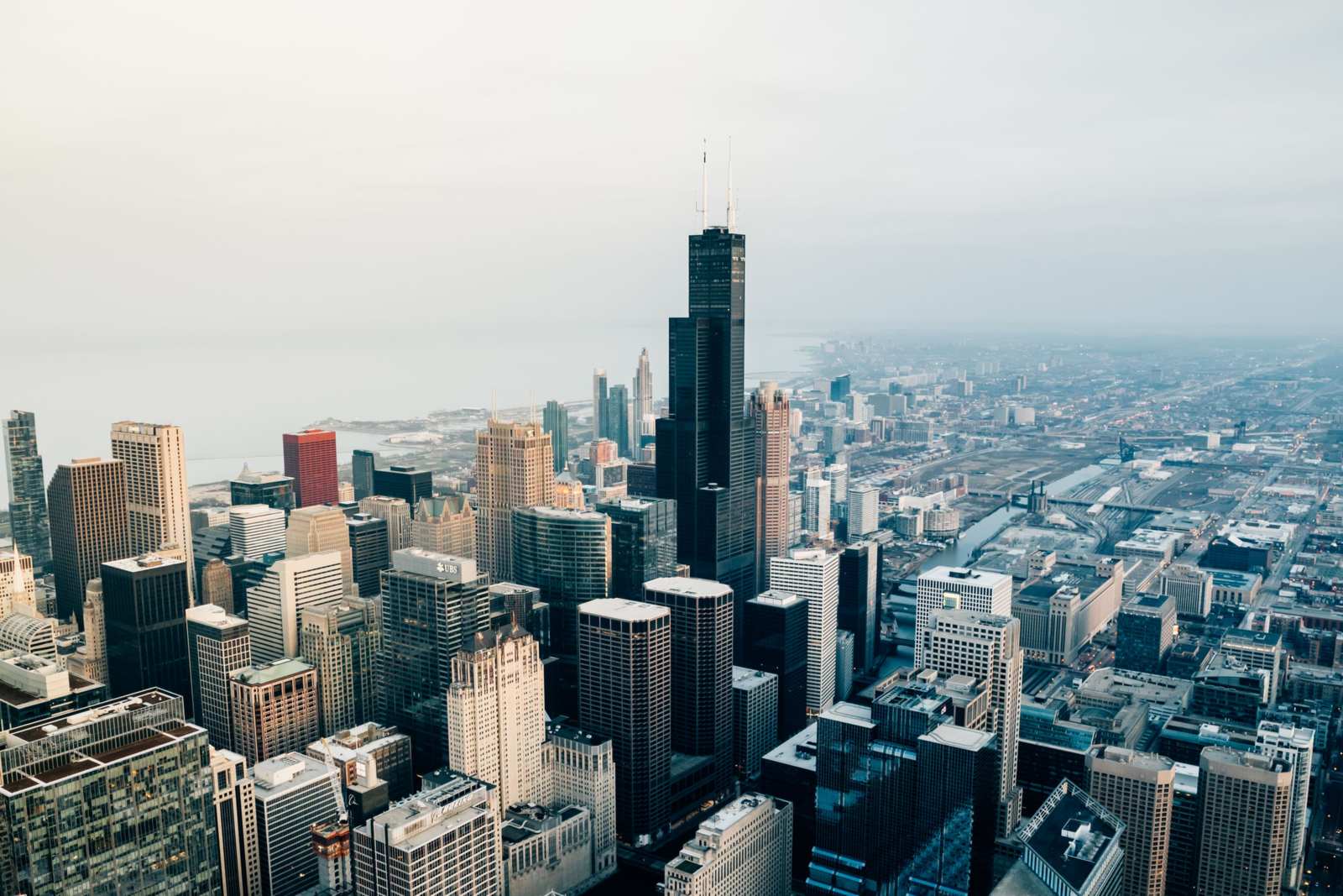 Aerial view of the Chicago skyline, with the black Willis Tower rising above the downtown skyscrapers