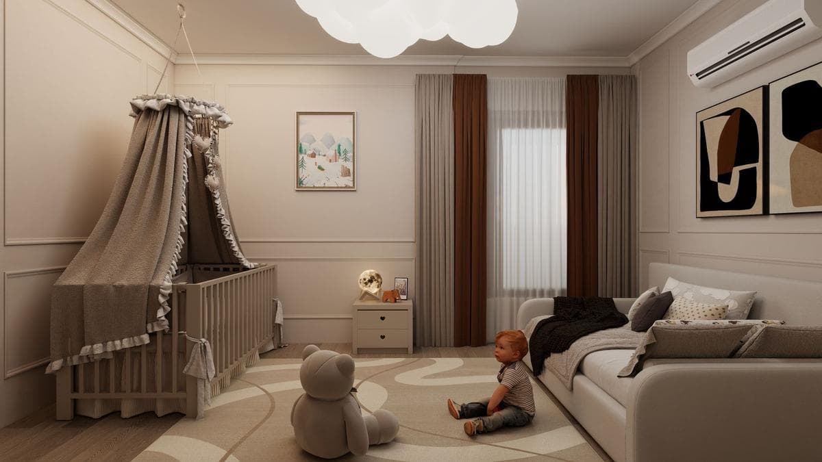 Soft neutral nursery with a canopied crib, framed pictures on the walls, and a baby playing on the floor